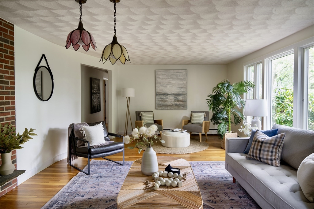 26 Hodge Road Arlington, MA 02474 - Photo 3 of 17 a living room with furniture a window and a chandelier