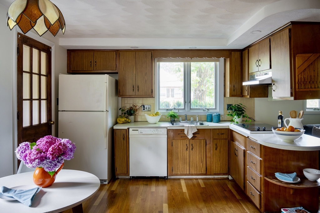 26 Hodge Road Arlington, MA 02474 - Photo 7 of 17 a kitchen with stainless steel appliances granite countertop a refrigerator sink and wooden cabinets