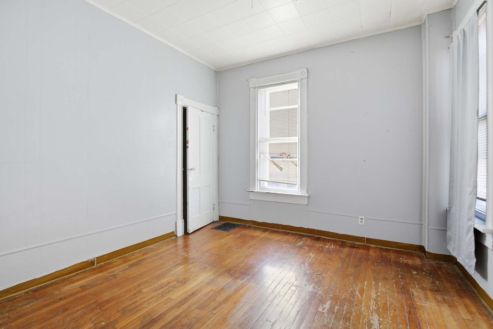 2115 West 4th Street Davenport, IA 52802 - Photo 16 of 24 an empty room with wooden floor and windows