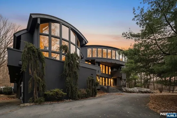 a living room with furniture a flat screen tv and a large window