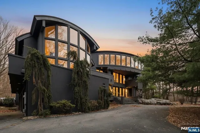 a living room with furniture a flat screen tv and a large window
