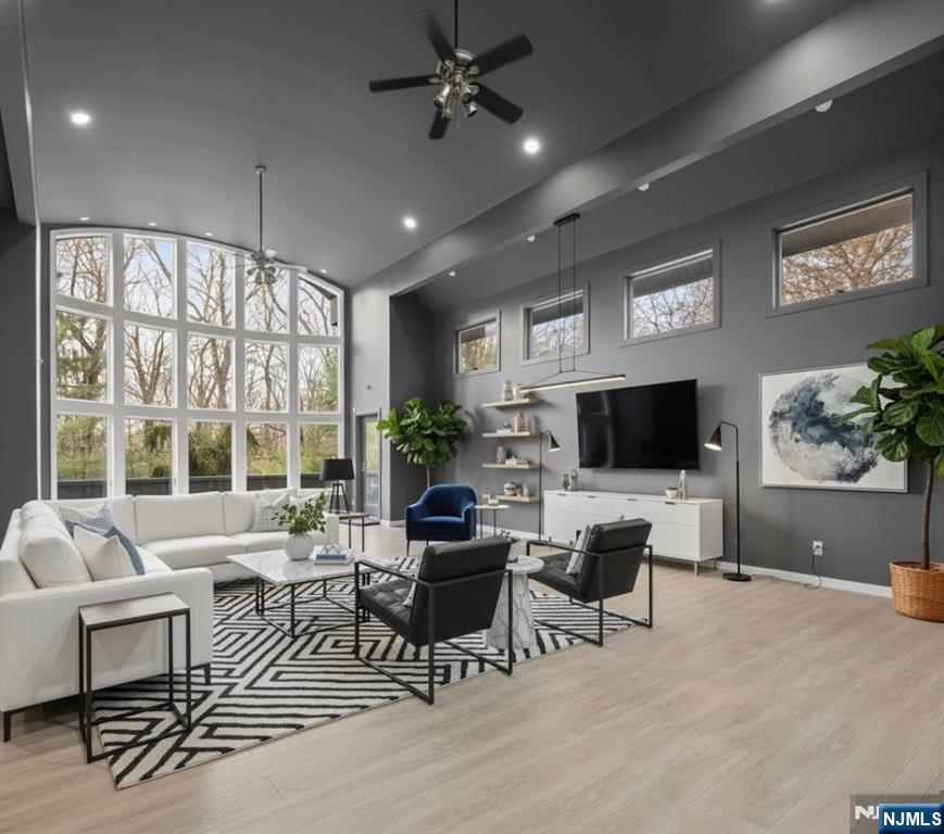 12 Smoke Rise Road Butler, NJ 07405 - Photo 2 of 21 a living room with furniture a flat screen tv and a large window