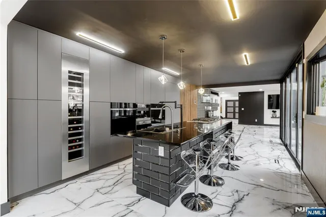 a view of a dining room with furniture large windows and wooden floor