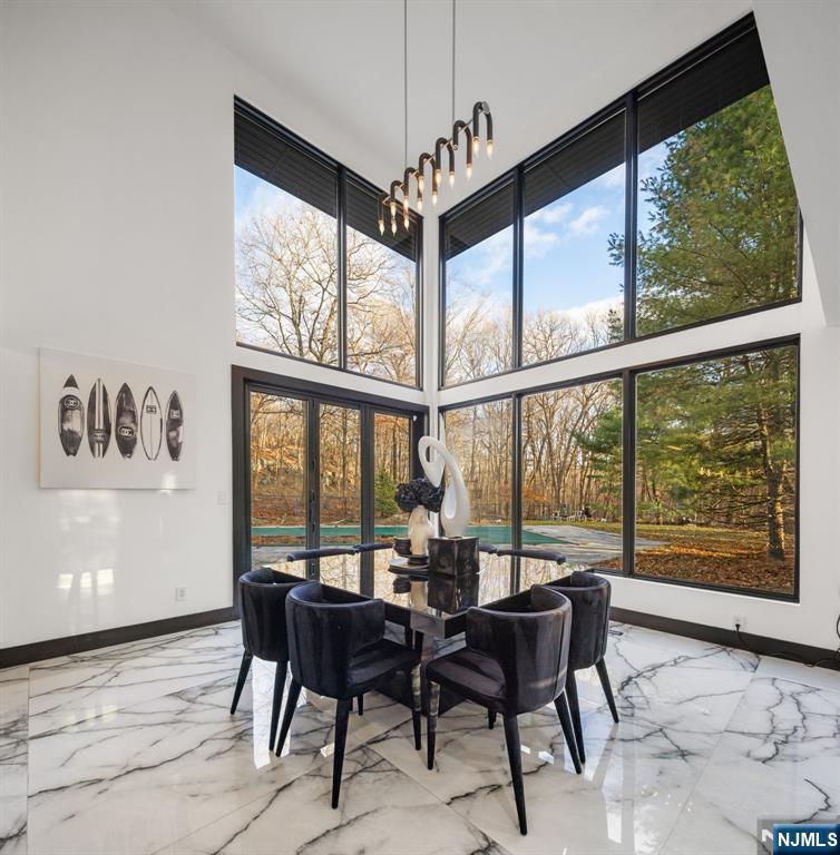 12 Smoke Rise Road Butler, NJ 07405 - Photo 4 of 21 a view of a dining room with furniture large windows and wooden floor