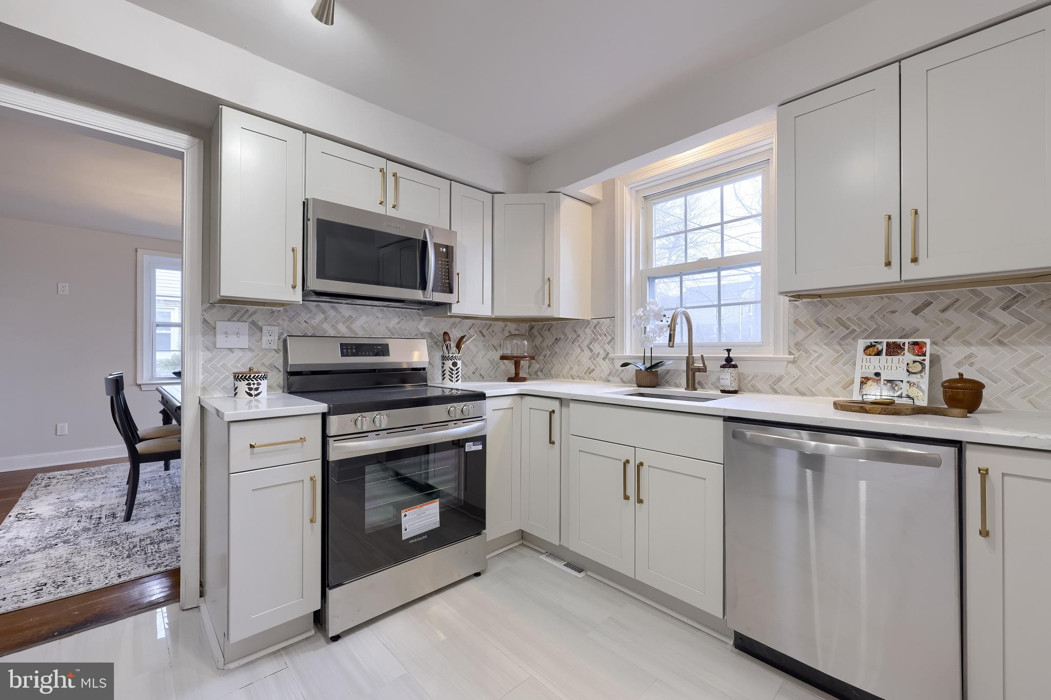 31 Wayfield Road Springfield, PA 19064 - Photo 17 of 49 a kitchen with white cabinets sink and stainless steel appliances