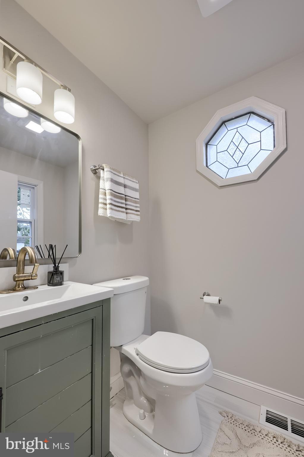 31 Wayfield Road Springfield, PA 19064 - Photo 23 of 49 a bathroom with a toilet a sink and mirror