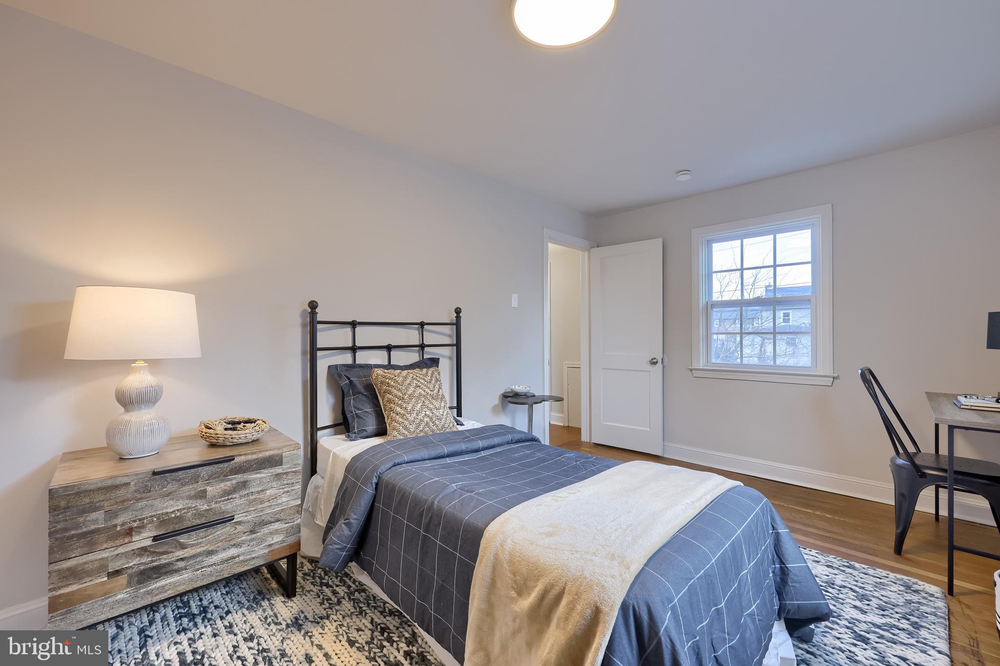 31 Wayfield Road Springfield, PA 19064 - Photo 33 of 49 a bedroom with a bed and a lamp on table