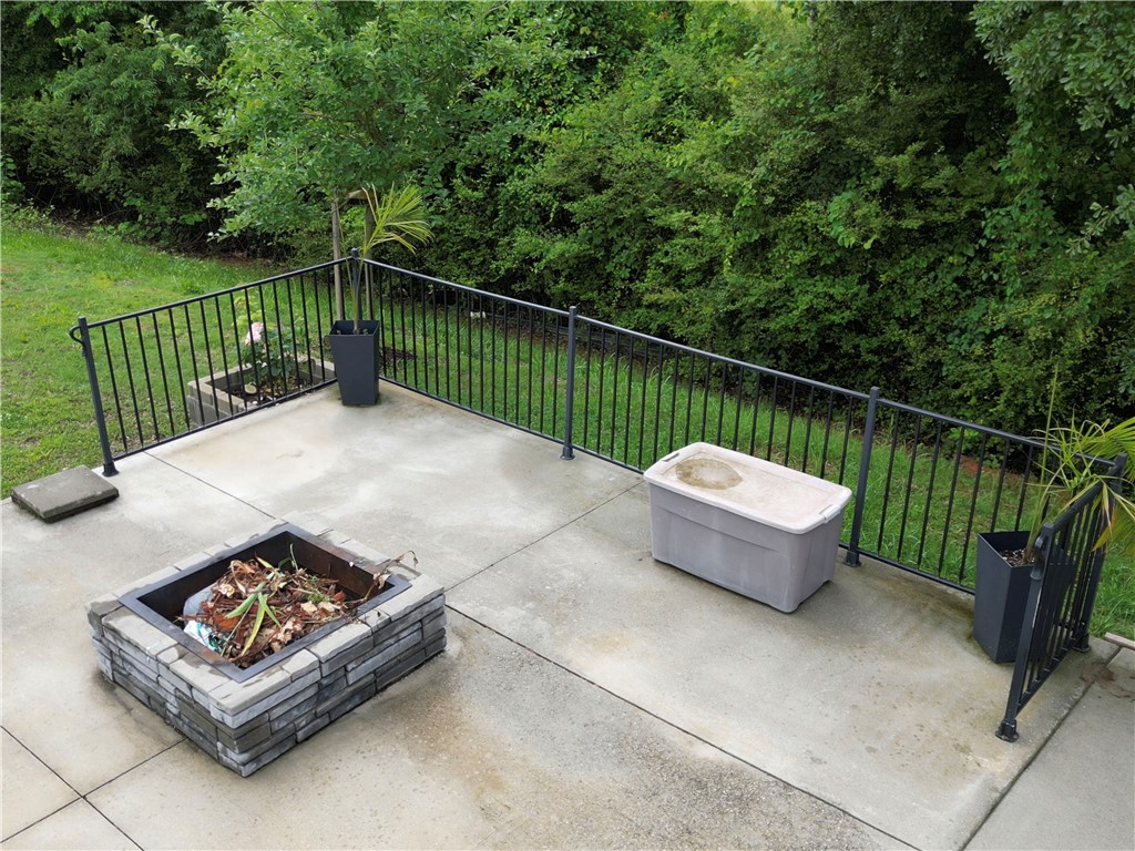 224 Bronson Ridge Anderson, SC 29621 - Photo 28 of 42 A well-defined concrete patio, perfect for evening gatherings, overlooks the verdant yard.
