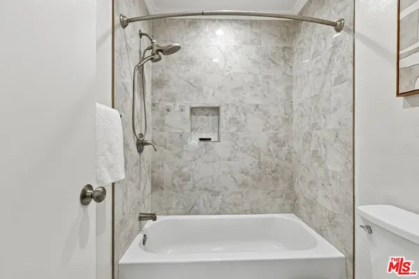a bathroom with a shower and a bath tub
