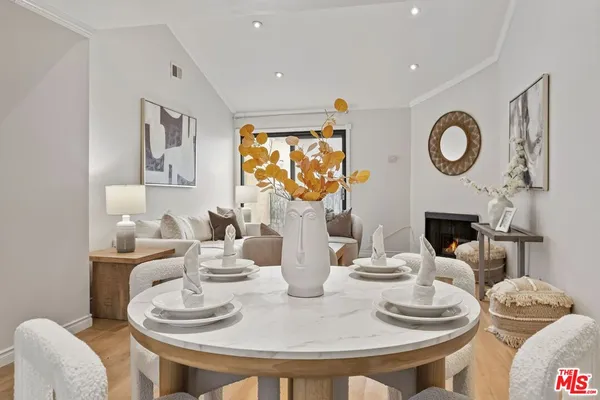 a dining room with furniture a rug and a fireplace