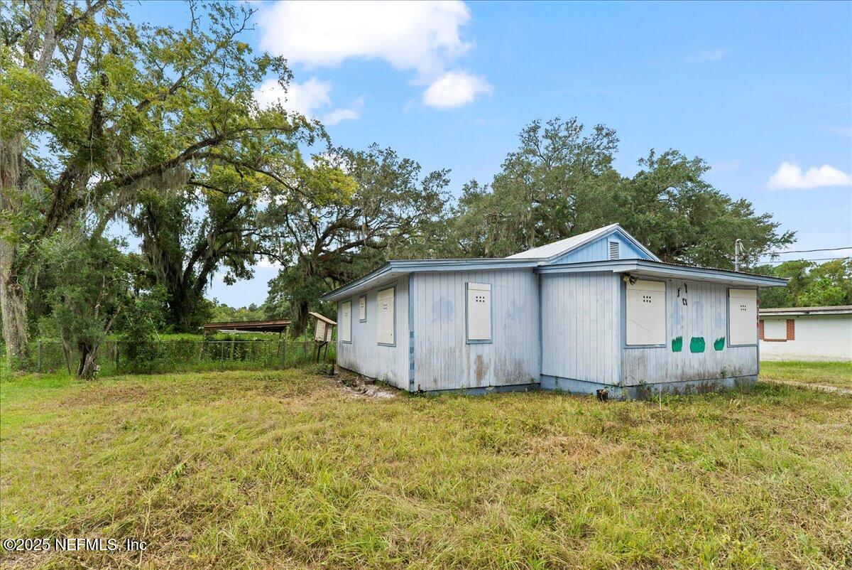 9044 Crystal Springs Road Jacksonville, FL 32221 - Photo 4 of 9 a wooden house with a yard