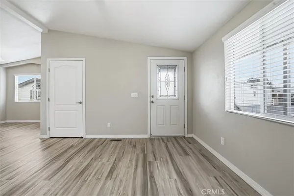 a view of a room with wooden floor and windows