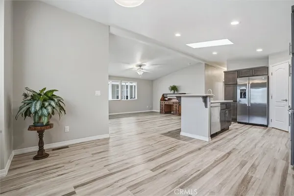 a view of a kitchen with wooden floor and a potted plant