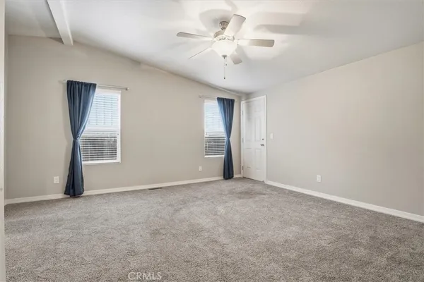 an empty room with windows and closet
