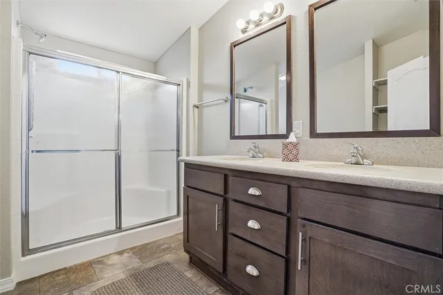 a bathroom with a double vanity sink mirror and double