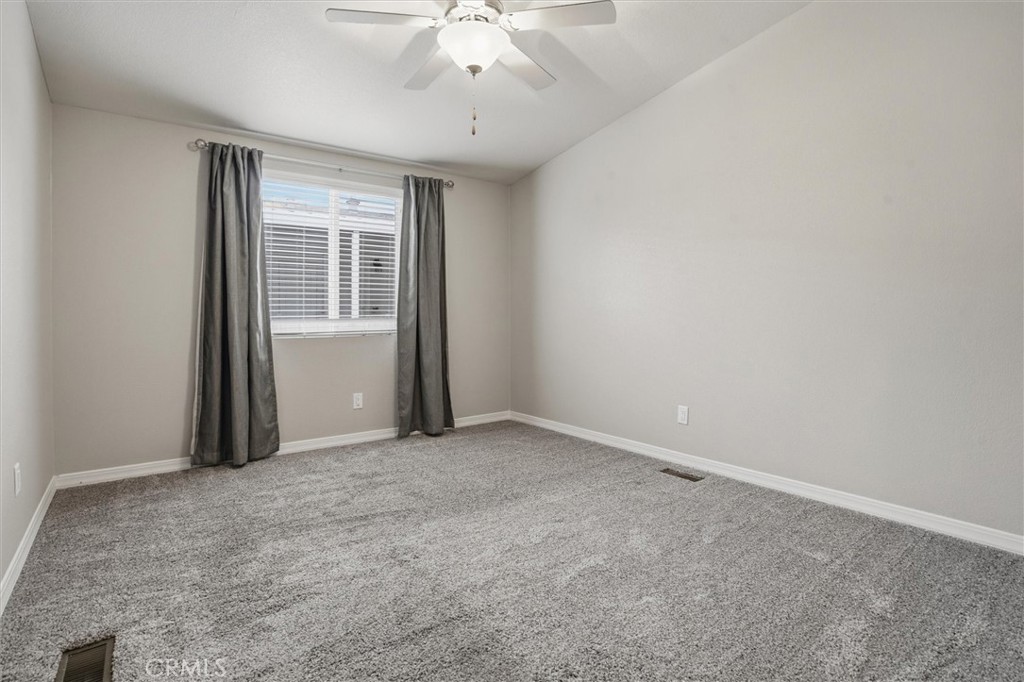 500 Atascadero Road Morro Bay, CA 93442 - Photo 26 of 43 an empty room with a chandelier fan and windows