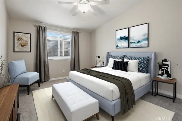 an empty room with a chandelier fan and windows