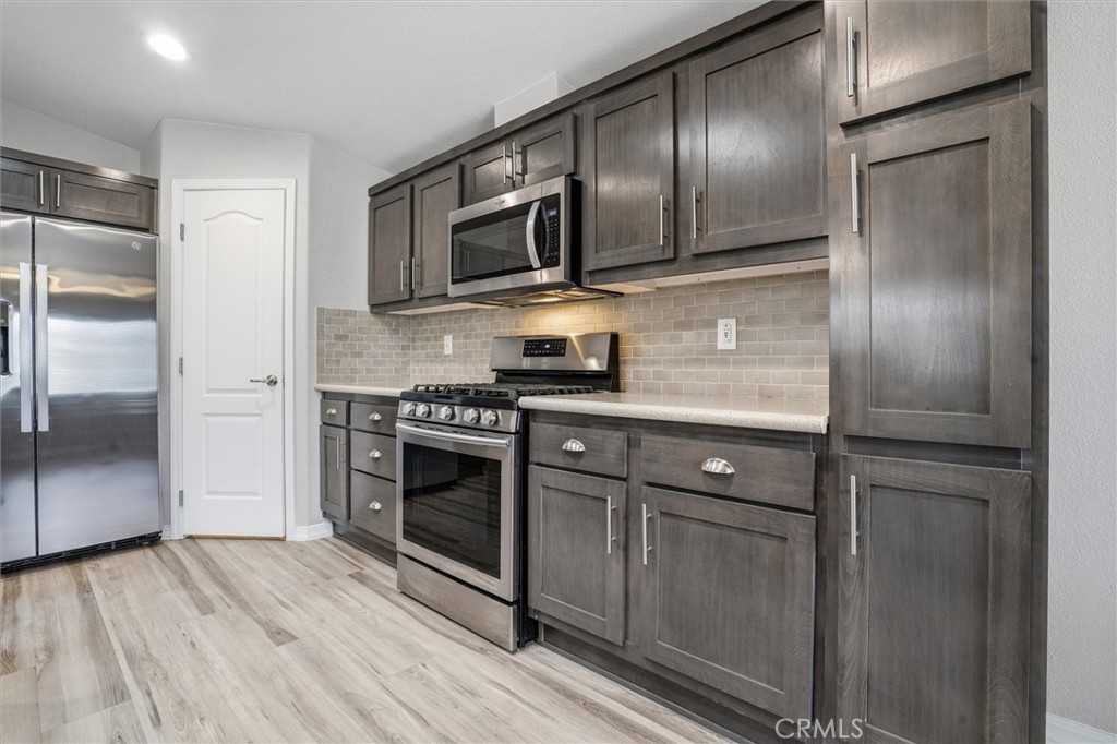 500 Atascadero Road Morro Bay, CA 93442 - Photo 7 of 43 a kitchen with stainless steel appliances granite countertop a stove a microwave and a refrigerator