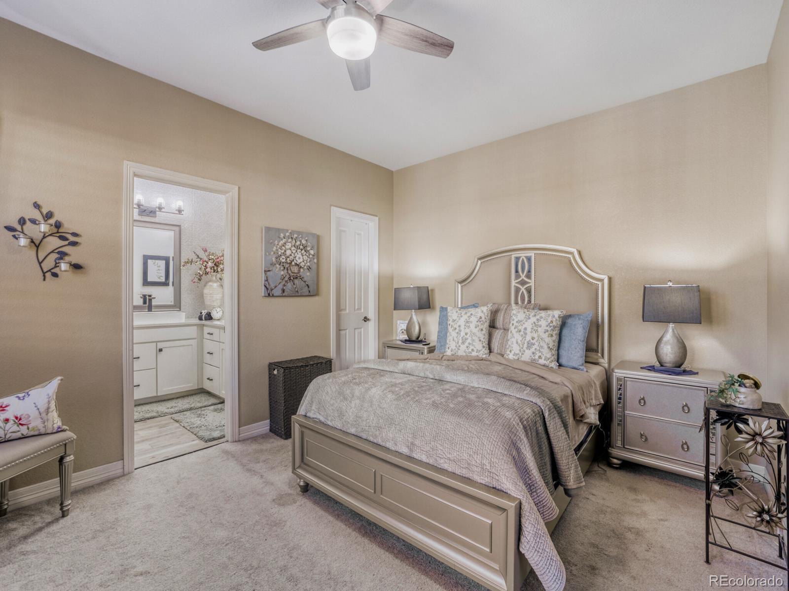 8893 Tappy Toorie Circle Highlands Ranch, CO 80129 - Photo 12 of 36 a bedroom with a bed and a chandelier