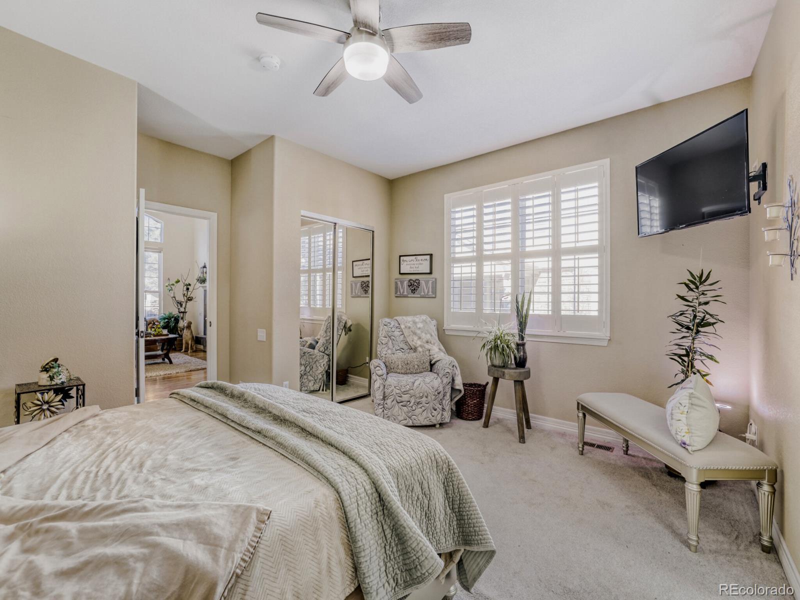8893 Tappy Toorie Circle Highlands Ranch, CO 80129 - Photo 13 of 36 a bedroom with a bed and a flat screen tv