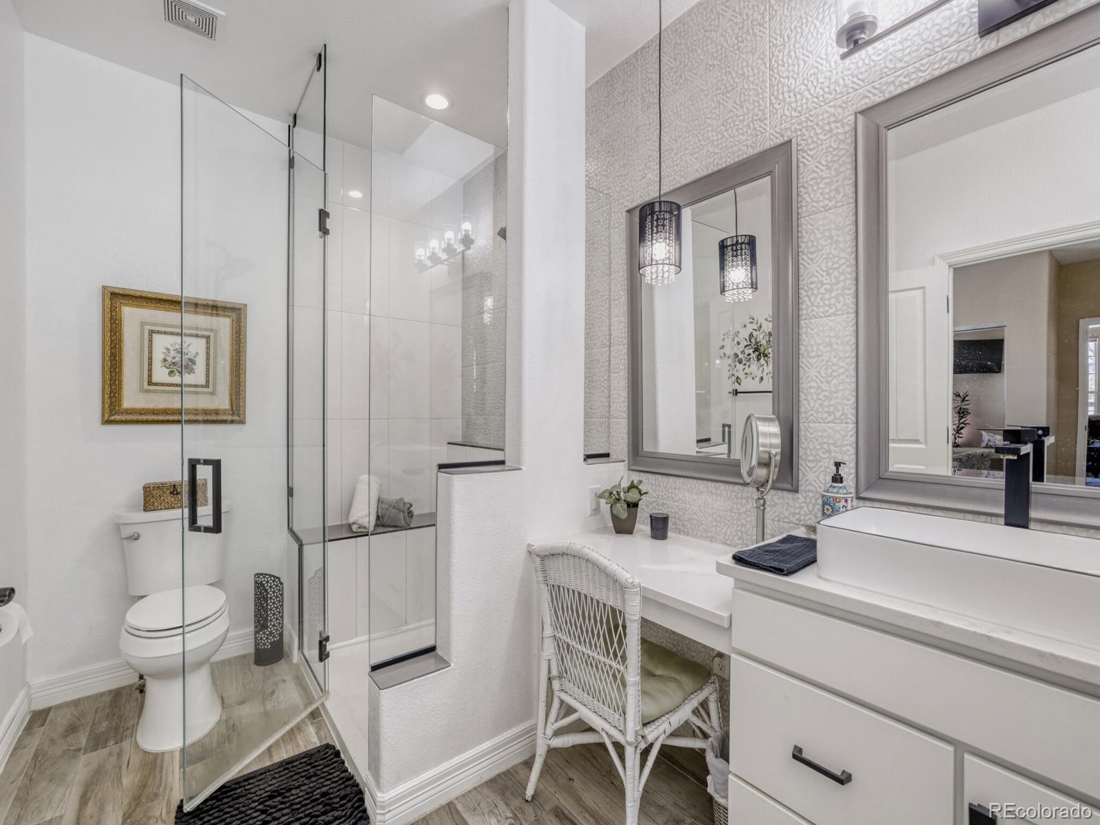 8893 Tappy Toorie Circle Highlands Ranch, CO 80129 - Photo 15 of 36 a bathroom with a double vanity sink toilet and shower