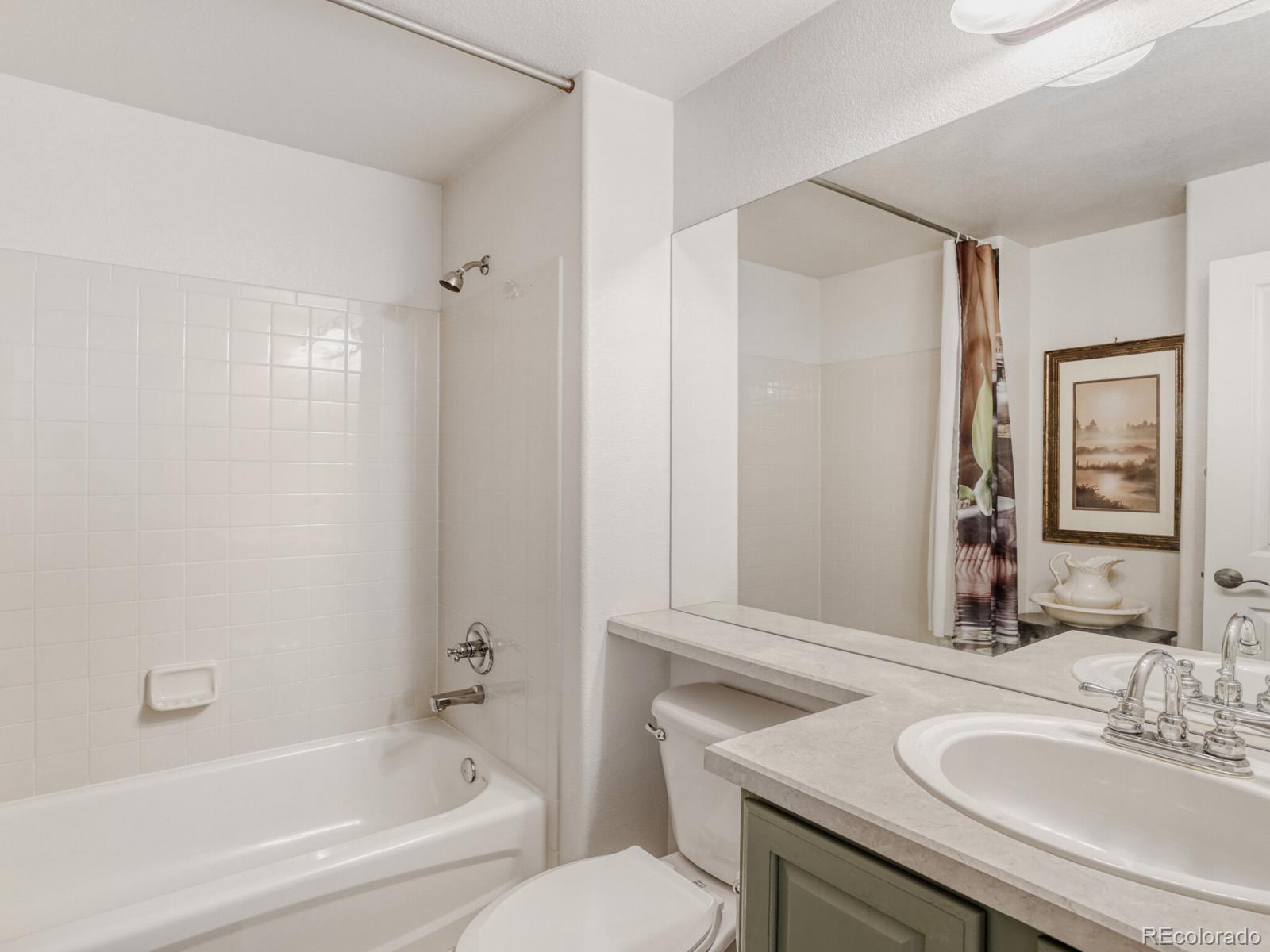 8893 Tappy Toorie Circle Highlands Ranch, CO 80129 - Photo 19 of 36 a bathroom with a granite countertop sink toilet and shower