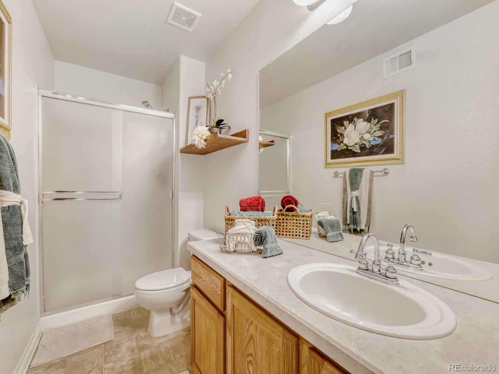 8893 Tappy Toorie Circle Highlands Ranch, CO 80129 - Photo 23 of 36 a bathroom with a sink toilet and shower