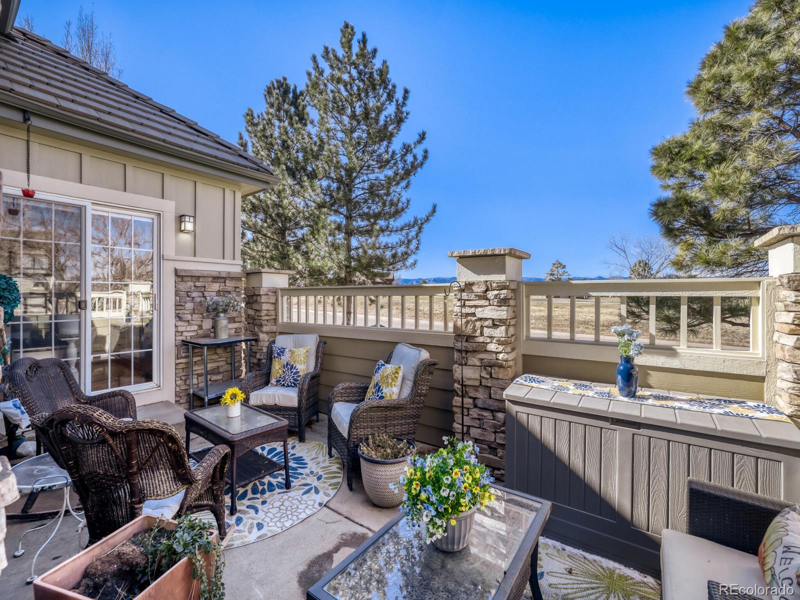 8893 Tappy Toorie Circle Highlands Ranch, CO 80129 - Photo 25 of 36 a view of a patio with couches table and chairs and potted plants