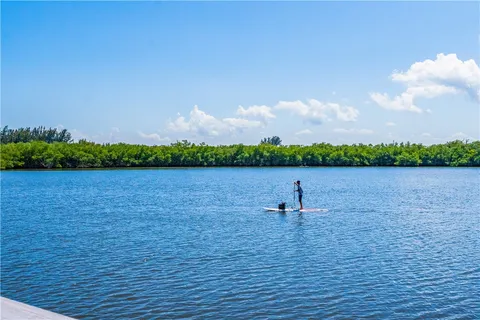 a swimming pool view with a seating space and a garden view