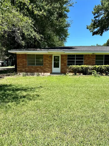 a backyard of a house with yard and barbeque oven