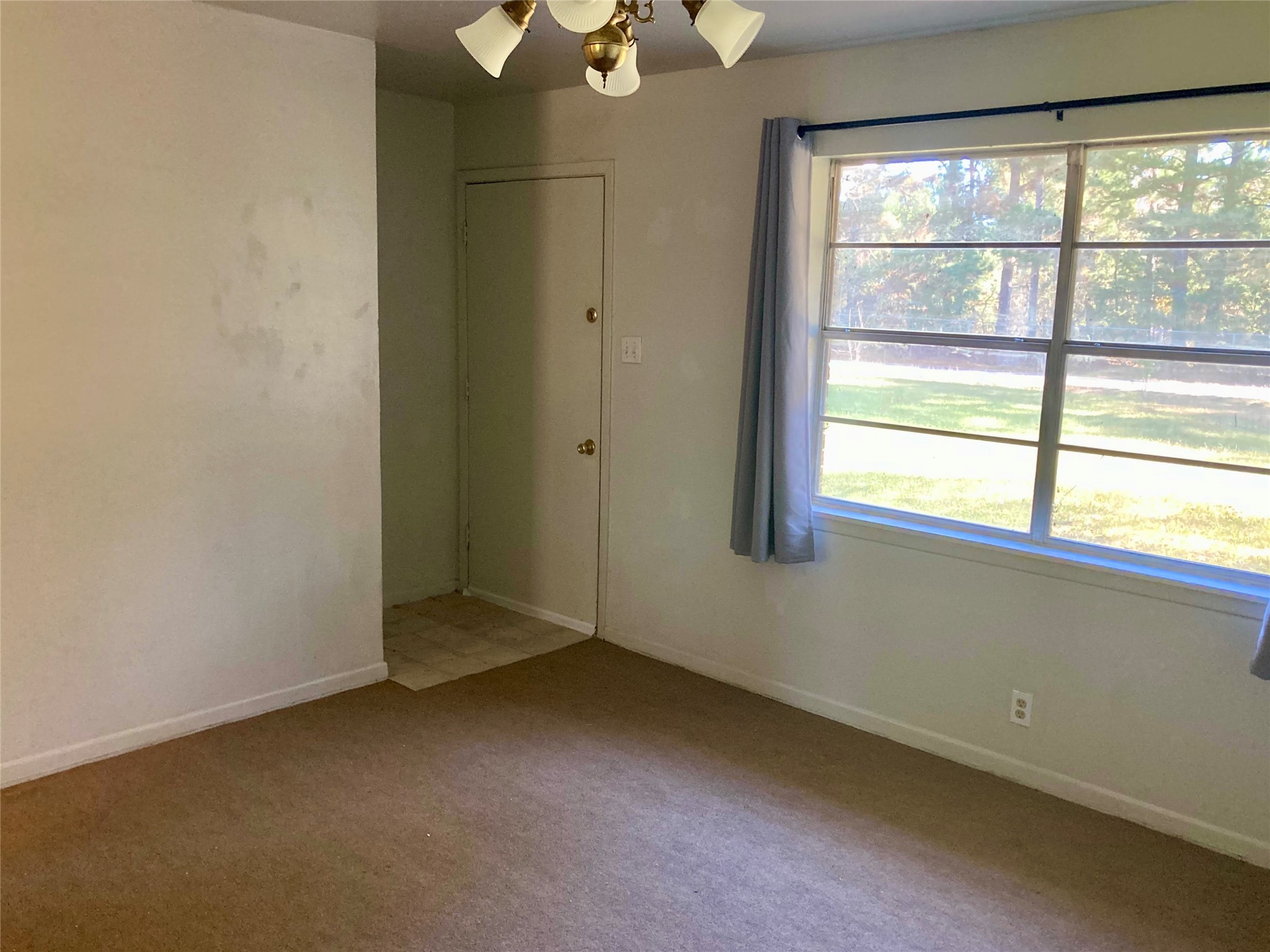 143 Moffett Springs Road, Unit A Huntsville, TX 77320 - Photo 5 of 16 an empty room with a window