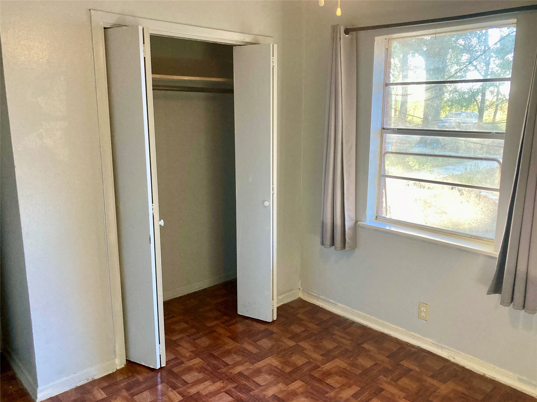 143 Moffett Springs Road, Unit A Huntsville, TX 77320 - Photo 10 of 16 a view of an empty room with wooden floor and a window