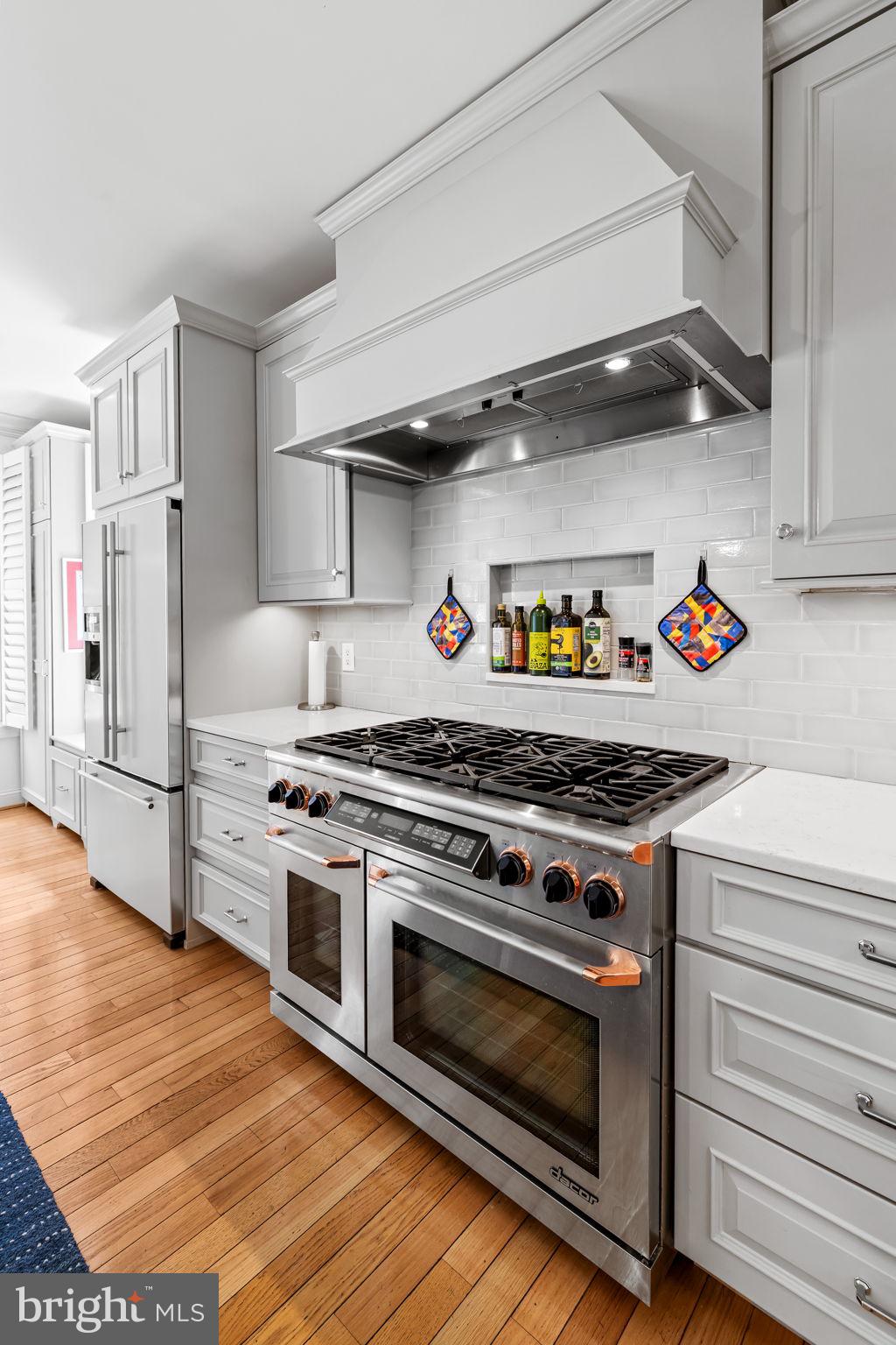 2331 Boston Street, Unit 1 Baltimore, MD 21224 - Photo 28 of 74 a kitchen with stainless steel appliances a stove and a refrigerator