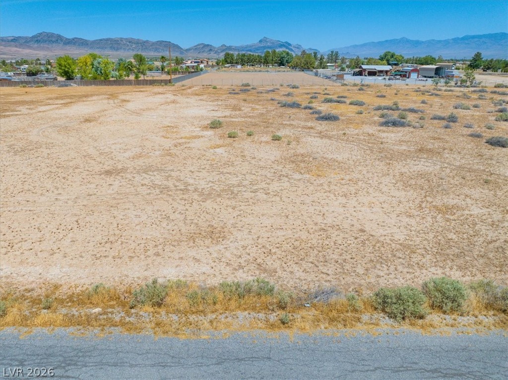 4610 Lawrence Road Pahrump, NV 89048 - Photo 20 of 42 A vast, undeveloped lot with distant mountain views, ready for your vision.