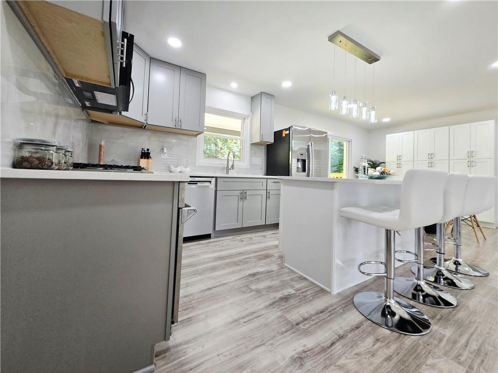 2400 Glenrock Drive Decatur, GA 30032 - Photo 11 of 39 a kitchen with kitchen island a stove a sink a refrigerator and cabinets