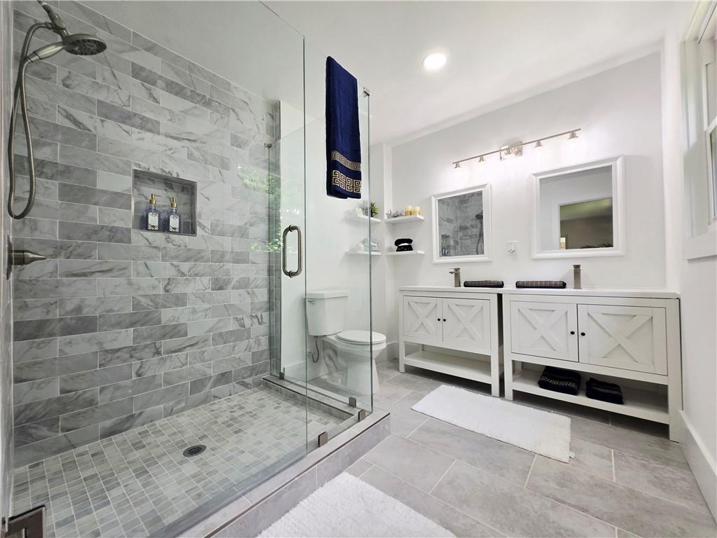2400 Glenrock Drive Decatur, GA 30032 - Photo 19 of 39 a bathroom with a double vanity sink mirror and shower