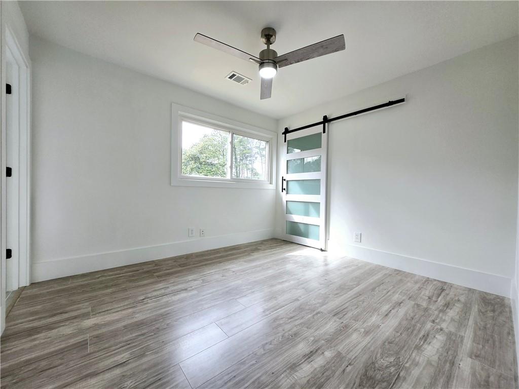 2400 Glenrock Drive Decatur, GA 30032 - Photo 24 of 39 wooden floor in an empty room with a window
