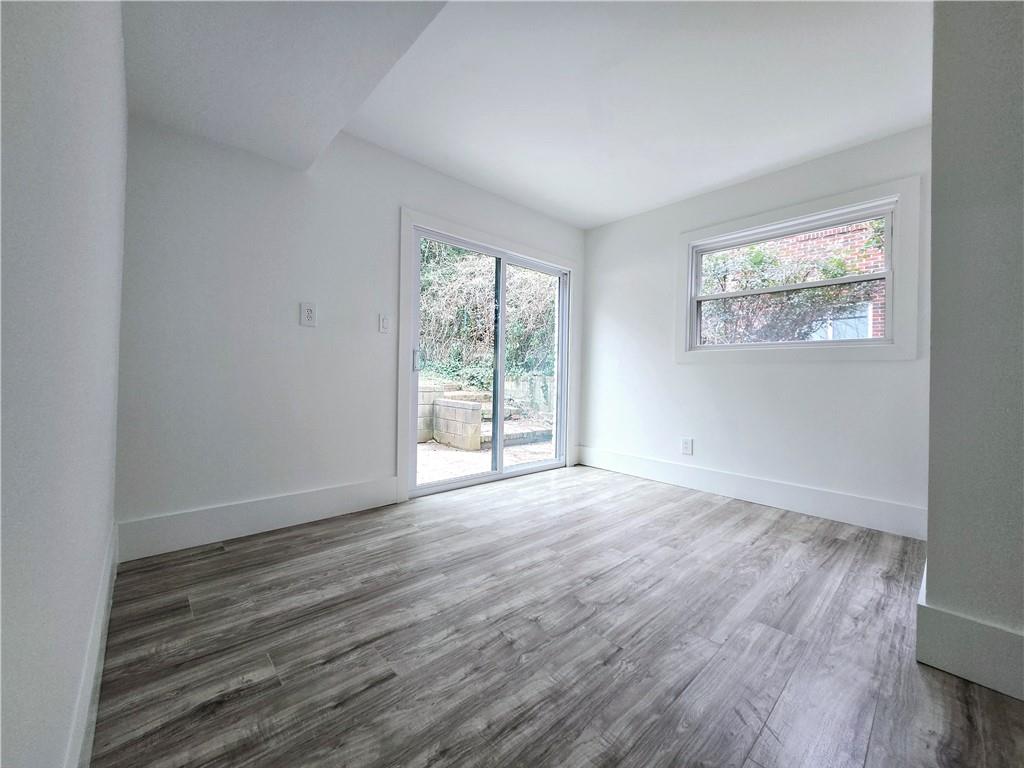 2400 Glenrock Drive Decatur, GA 30032 - Photo 27 of 39 an empty room with wooden floor and windows