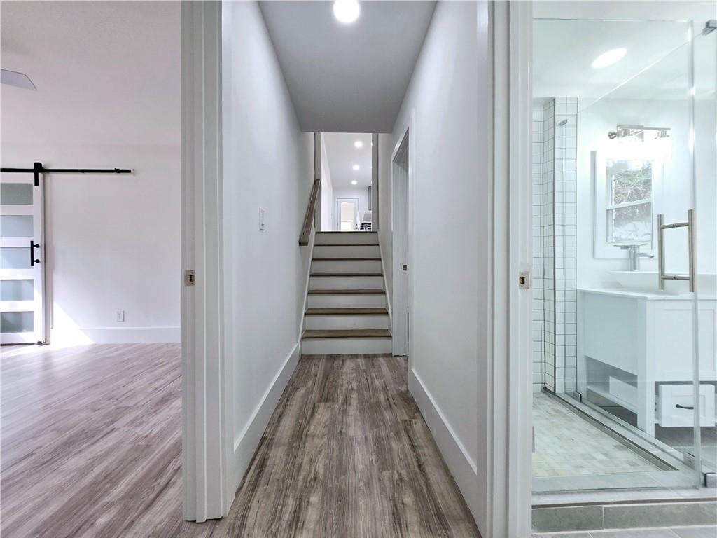 2400 Glenrock Drive Decatur, GA 30032 - Photo 30 of 39 a view of a hallway with wooden floor and staircase