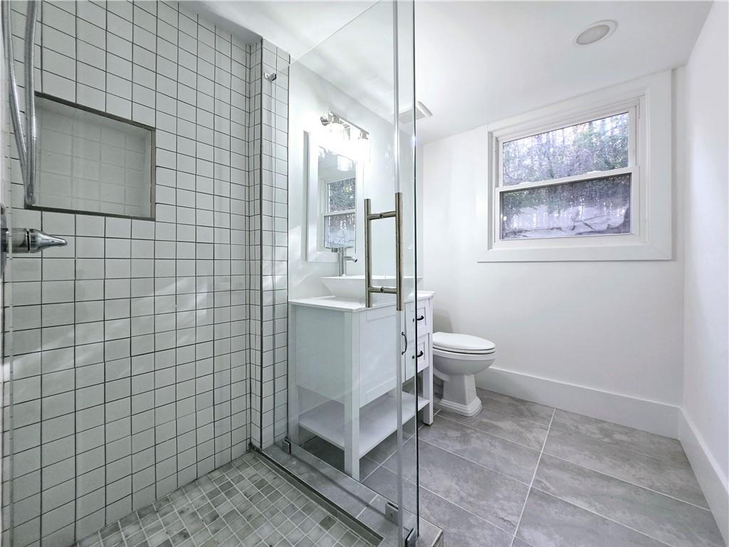 2400 Glenrock Drive Decatur, GA 30032 - Photo 32 of 39 a bathroom with a toilet sink and shower