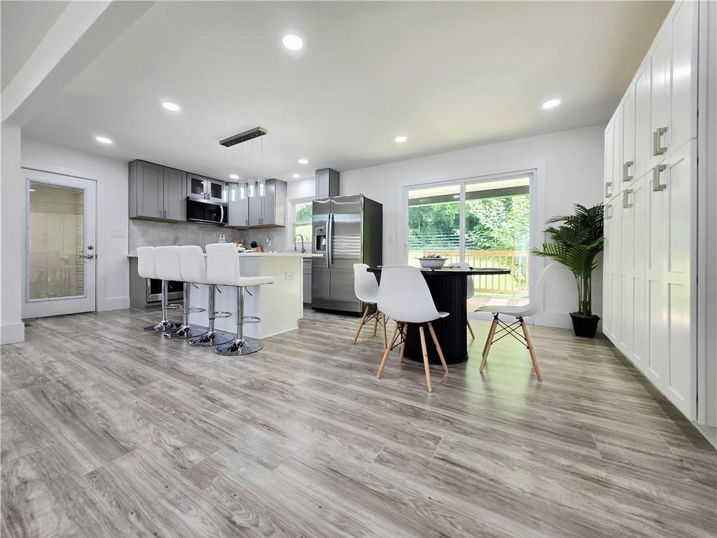 2400 Glenrock Drive Decatur, GA 30032 - Photo 10 of 39 a living room with furniture and a dining table with kitchen view