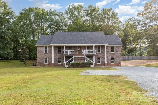 a view of a house with a swimming pool and sitting area