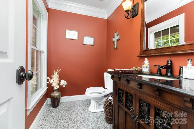 a bathroom with a toilet a sink and a window