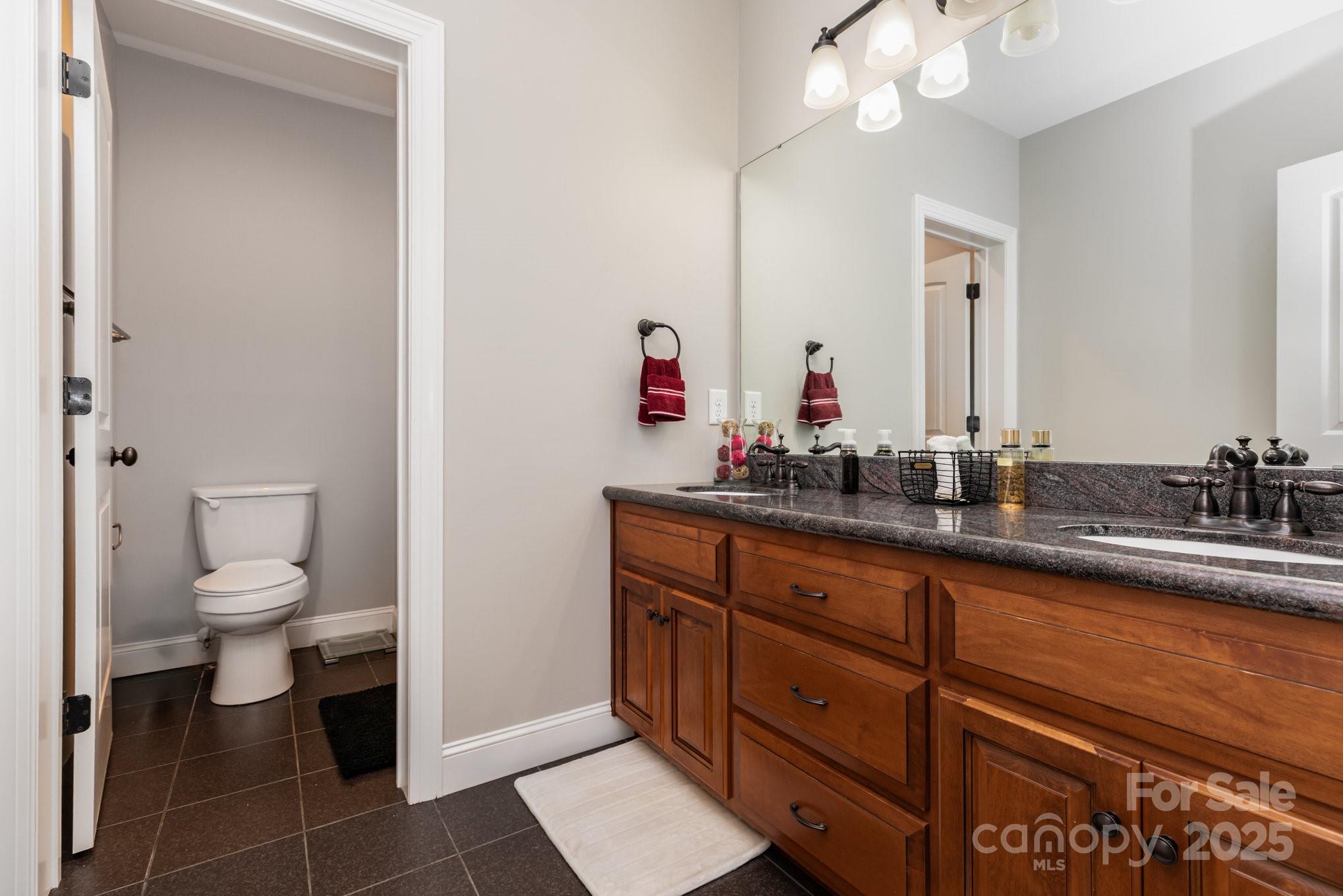 3351 Beulah Church Road Matthews, NC 28104 - Photo 16 of 33 a bathroom with a toilet sink and mirror