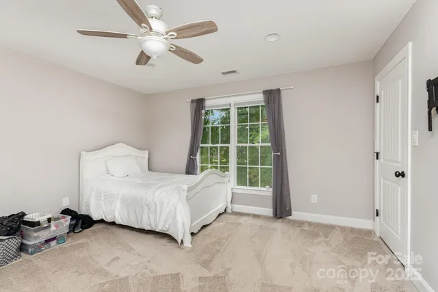 a spacious bedroom with a bed and a window