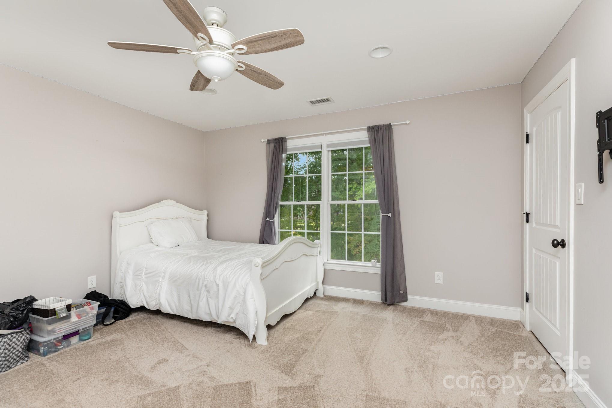 3351 Beulah Church Road Matthews, NC 28104 - Photo 17 of 33 a spacious bedroom with a bed and a window