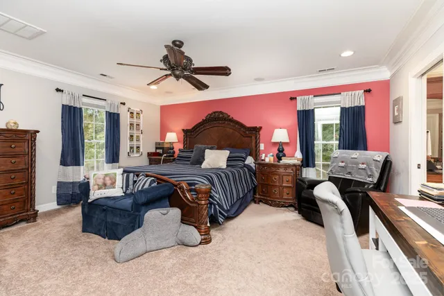 a bedroom with furniture and a chandelier
