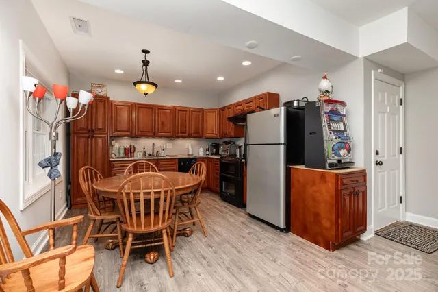 a kitchen with stainless steel appliances granite countertop a refrigerator and a sink