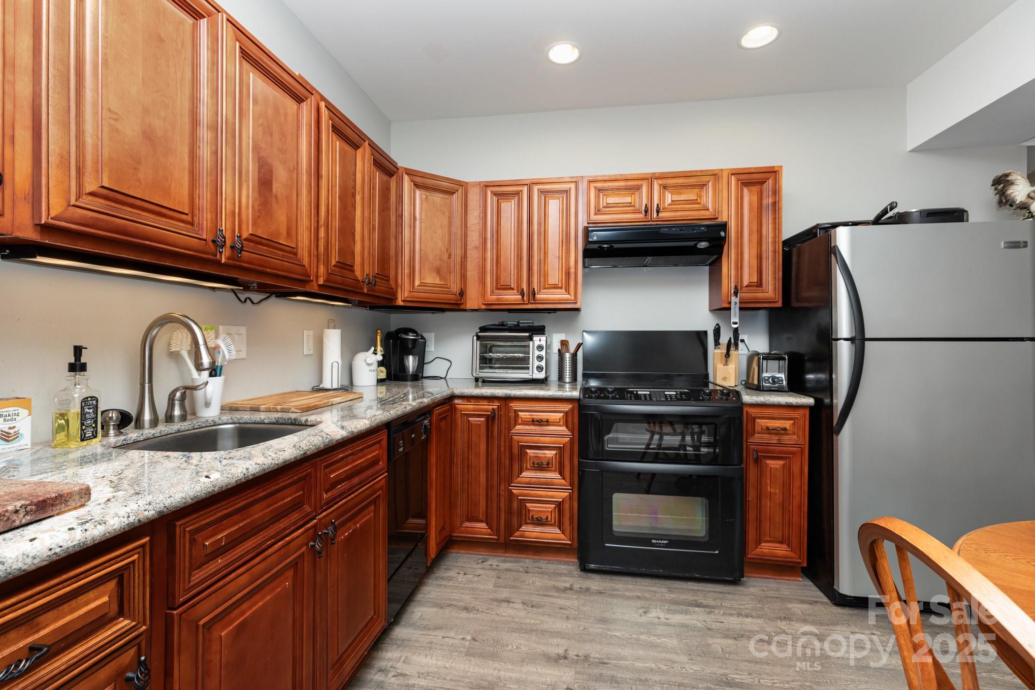 3351 Beulah Church Road Matthews, NC 28104 - Photo 27 of 33 a kitchen with stainless steel appliances granite countertop a stove refrigerator and a sink