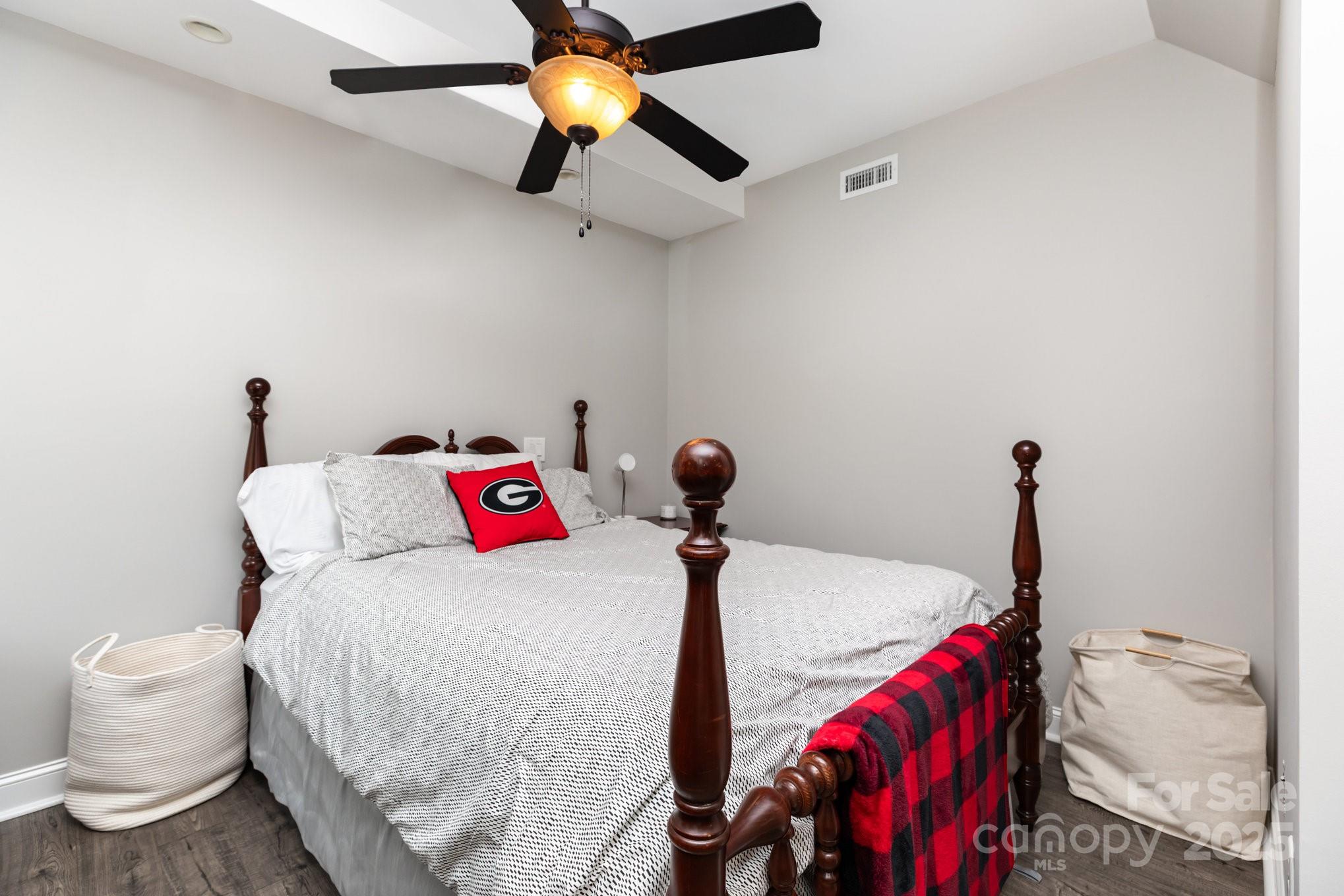 3351 Beulah Church Road Matthews, NC 28104 - Photo 28 of 33 a bedroom with a bed and a chandelier